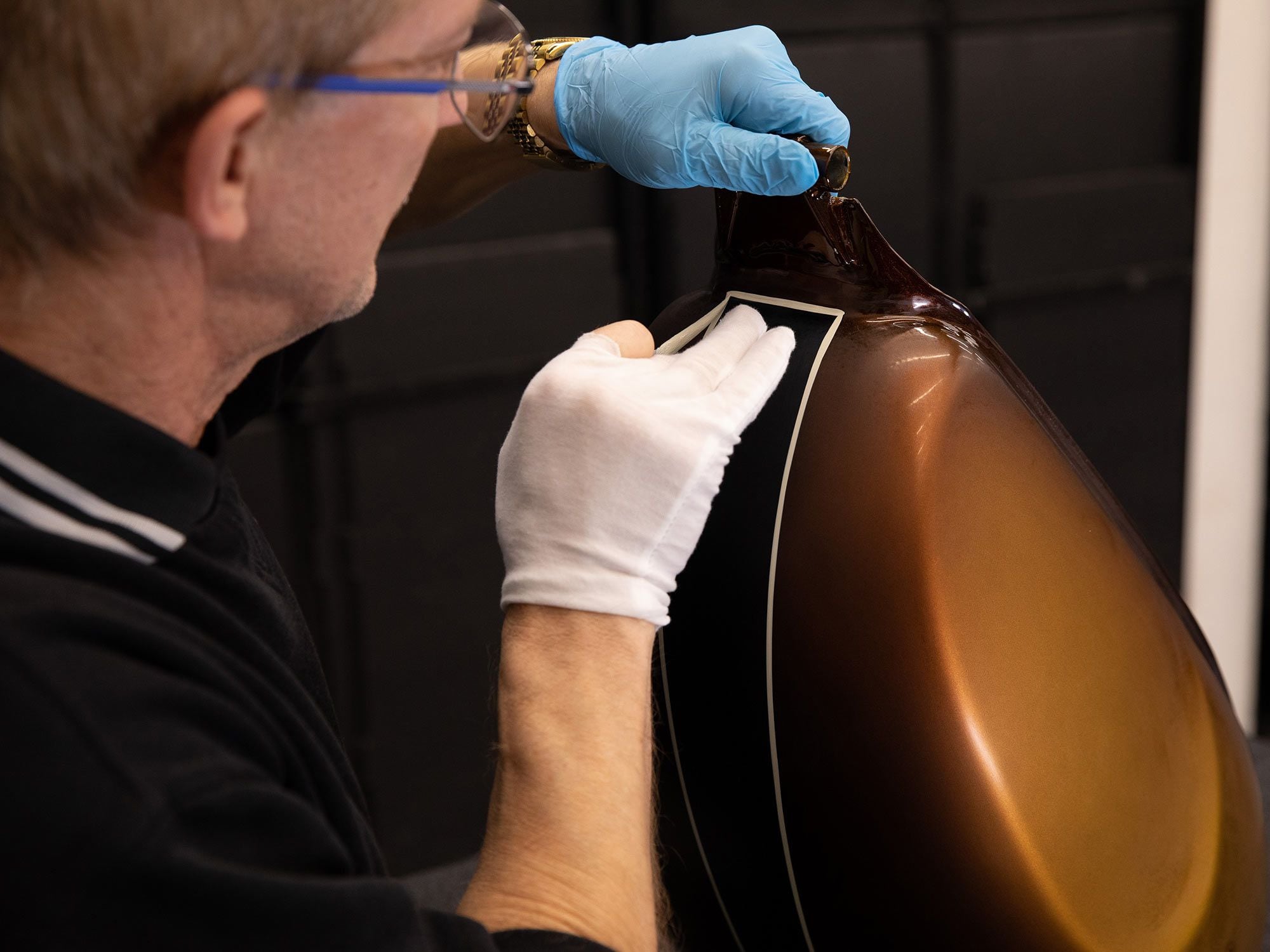 Triumph’s paint pros went to work on the hand-applied coachlines in the factory workshop.