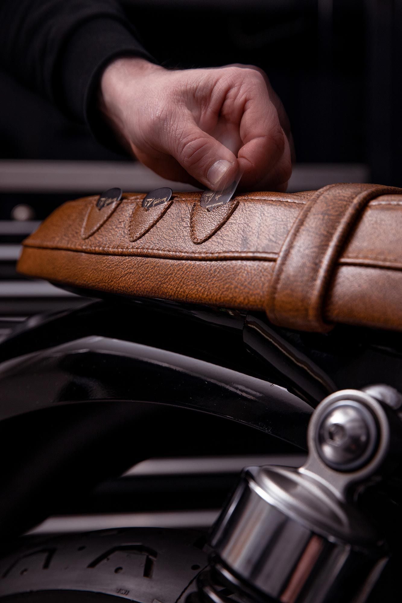 Custom Bonneville’s special brown leather seat even has integrated pick holders, in case you feel like breaking out the jams at a stoplight.