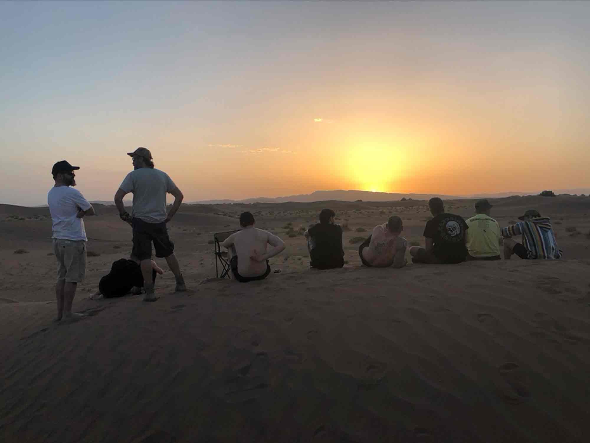 The team sits on a dune to appreciate the sunset after one of our toughest days. Nothing brings people together like a challenge, and this ride was one hell of a challenge.