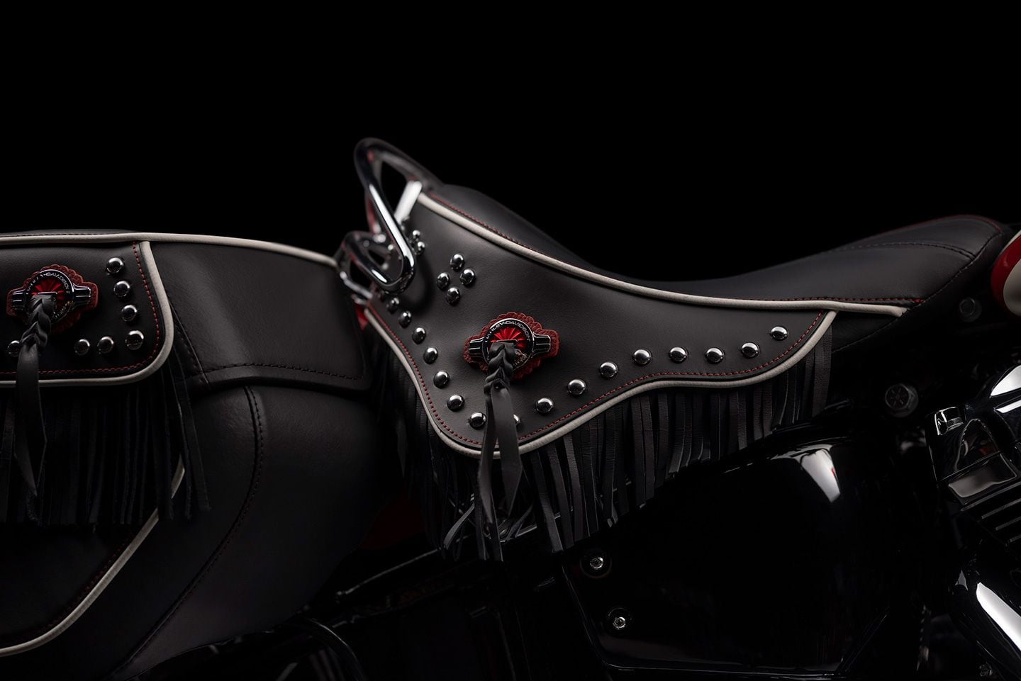 Solo saddle gets fringed and leathered, with white piping, red stitching, and chrome rail for a vintage look.