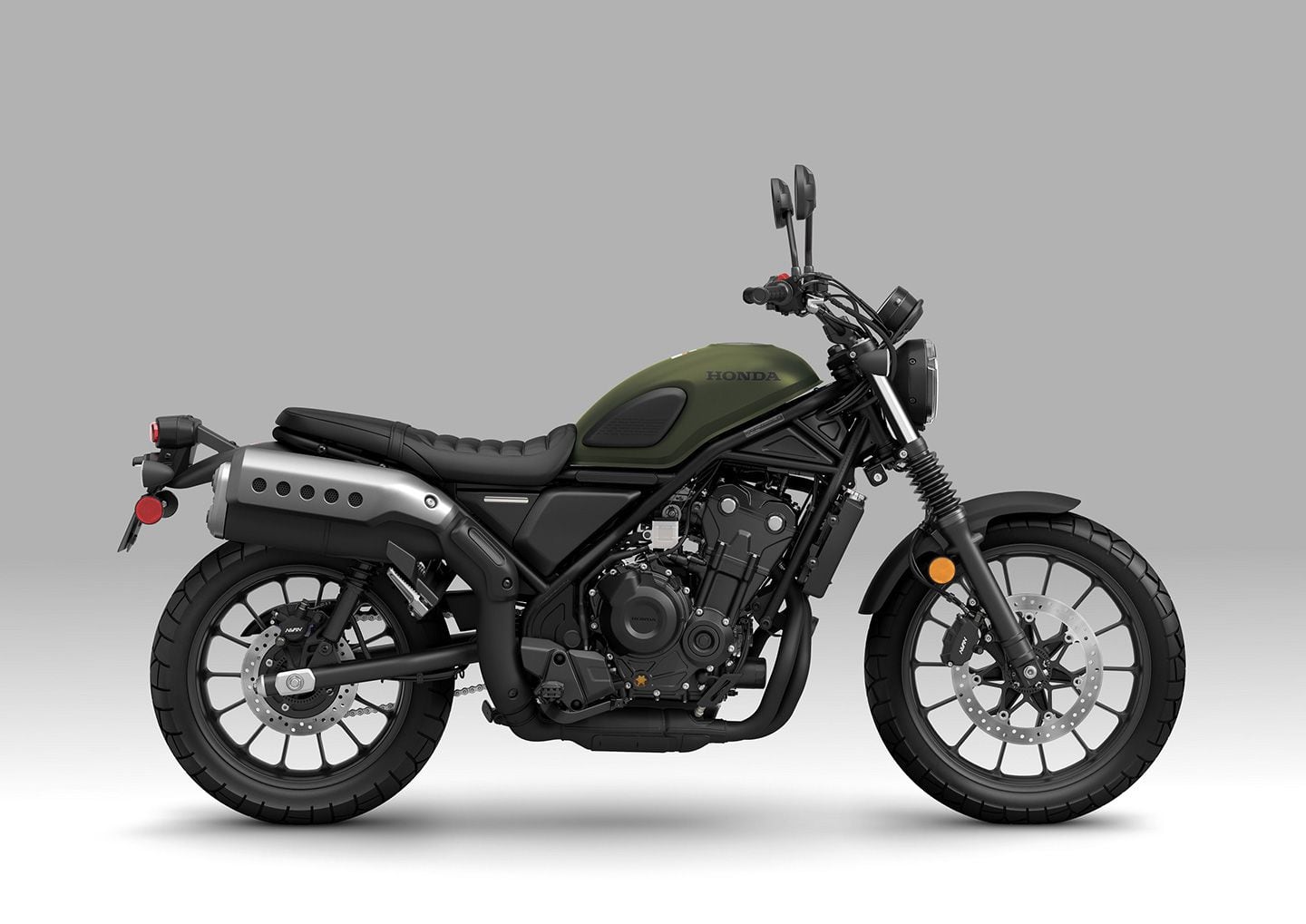 The 2024 SCL500 retains retro cues like tank pads, high-mount exhaust, and retro fork gaiters. Underneath the scrambler styling, though, it shares the 471cc engine and main frame with the Rebel 500.