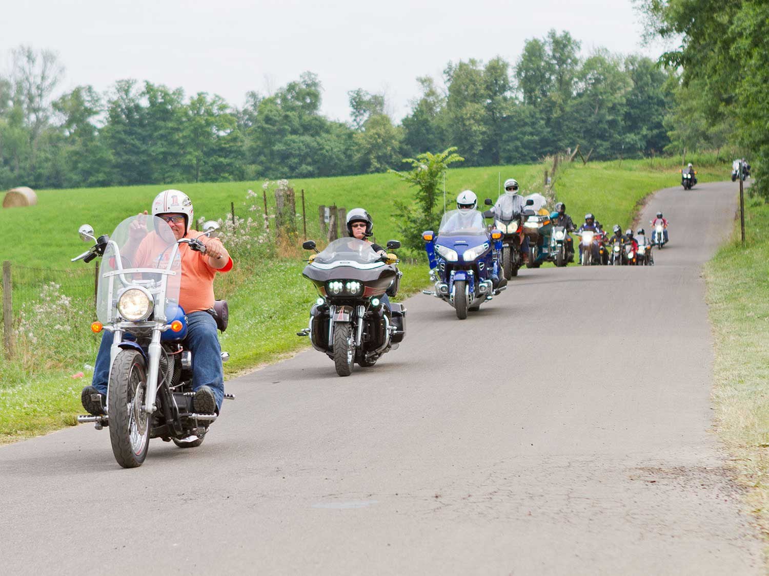 Touring bikes come in all shapes and sizes. A H-D cruiser up front, followed by a Road Glide and a Honda Gold Wing.