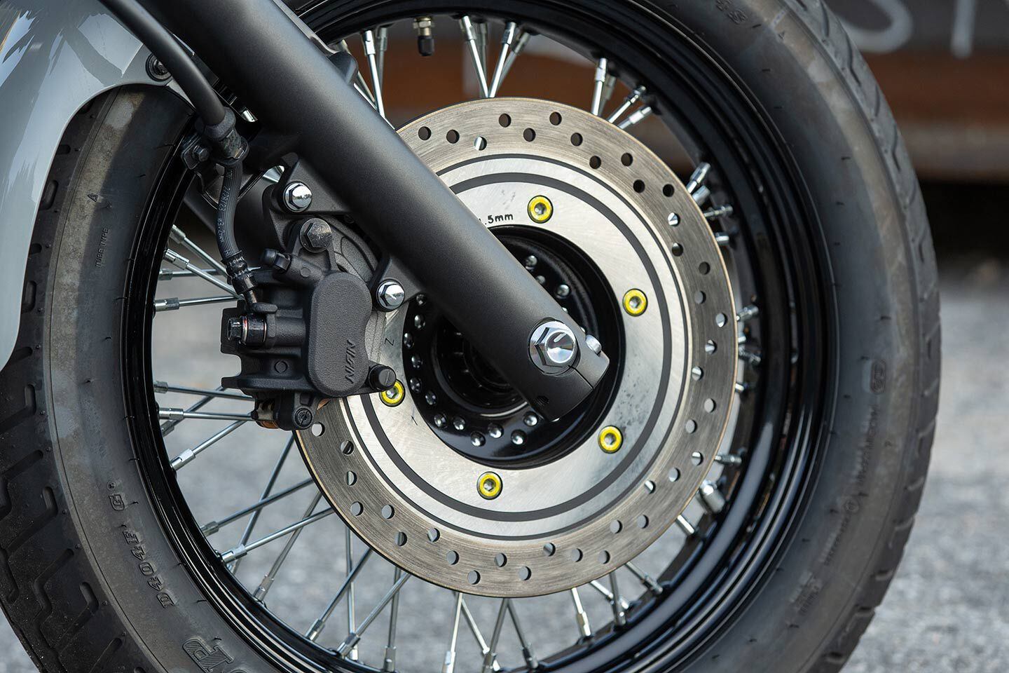 The standard fork provides 5.1 inches of travel, while a single 296mm disc is pinched by a twin-piston caliper.