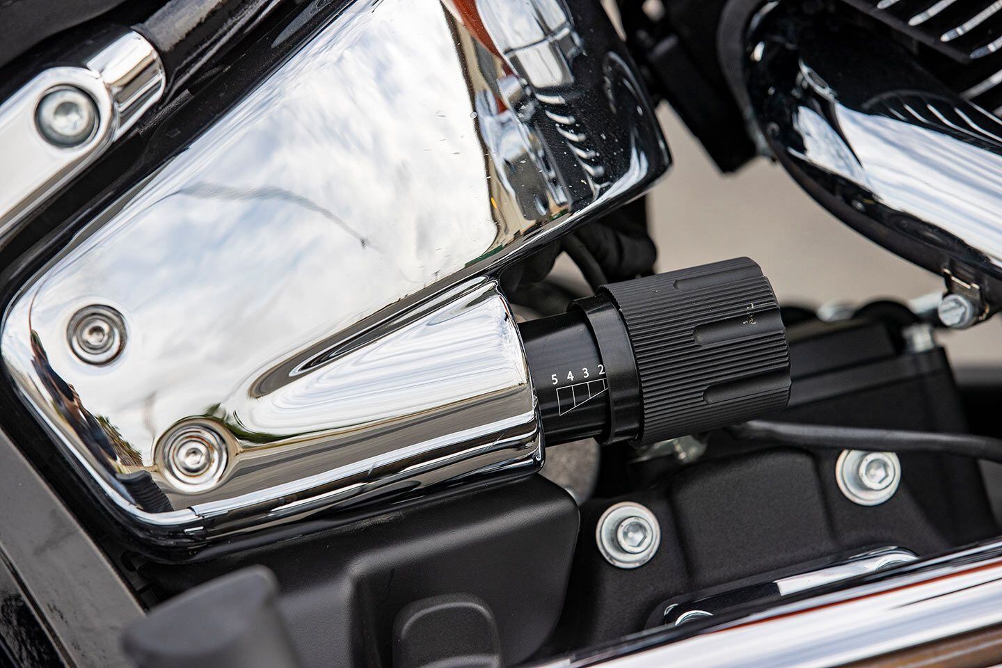 The hidden rear shock has provisions for spring-preload adjustability via this toolless adjuster.