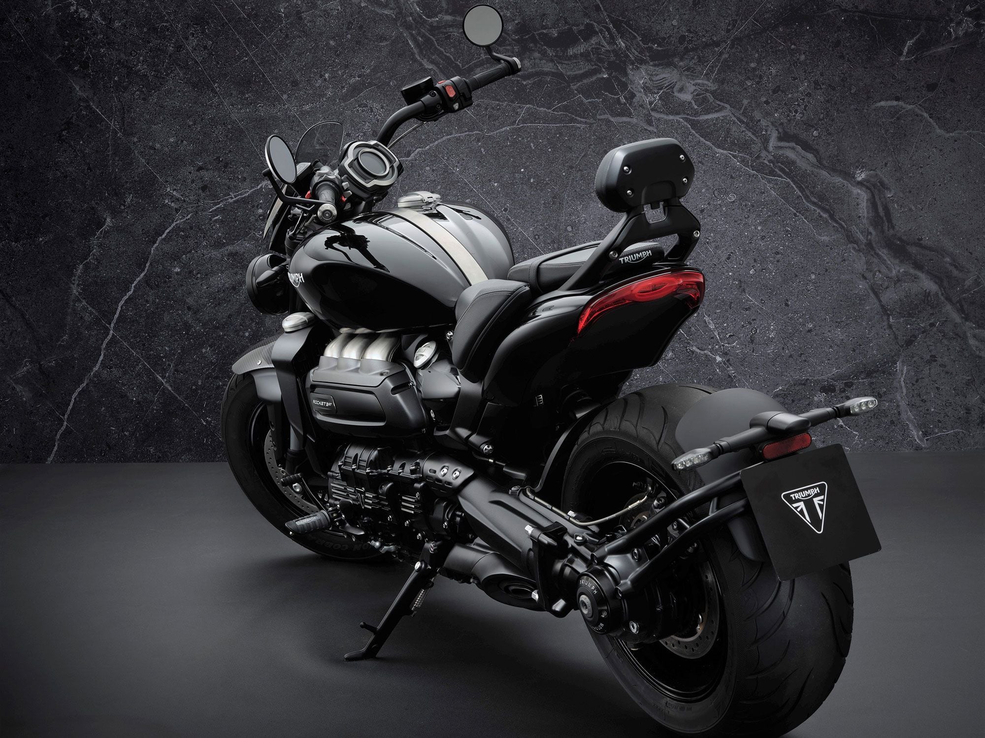 The swingarm guard and even details like the sidestand, bar-end mirrors, footrests, and brake pedal were blacked out. Shown is the GT Triple Black.