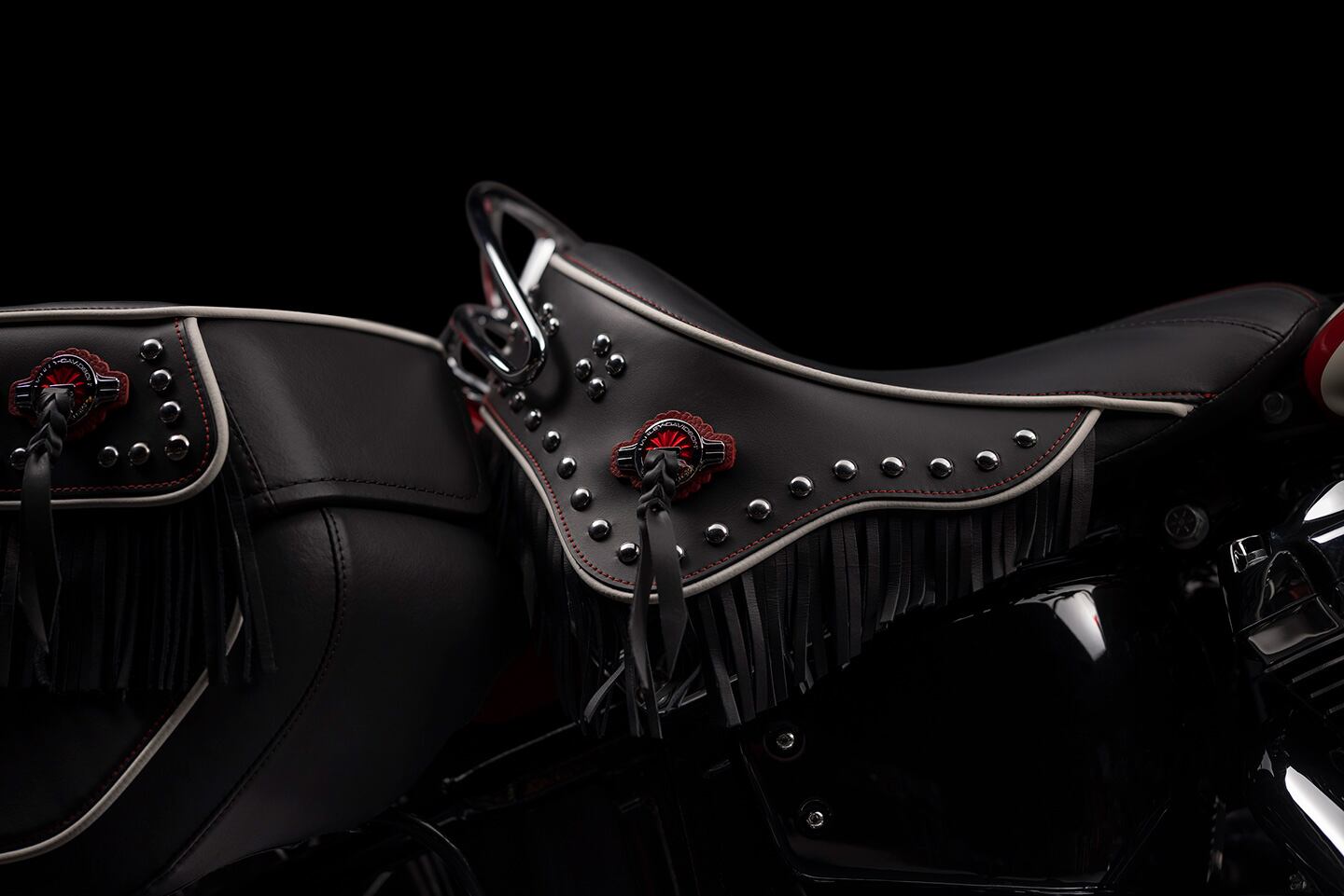 Solo saddle gets fringed and leathered, with white piping, red stitching, and chrome rail for a vintage look.