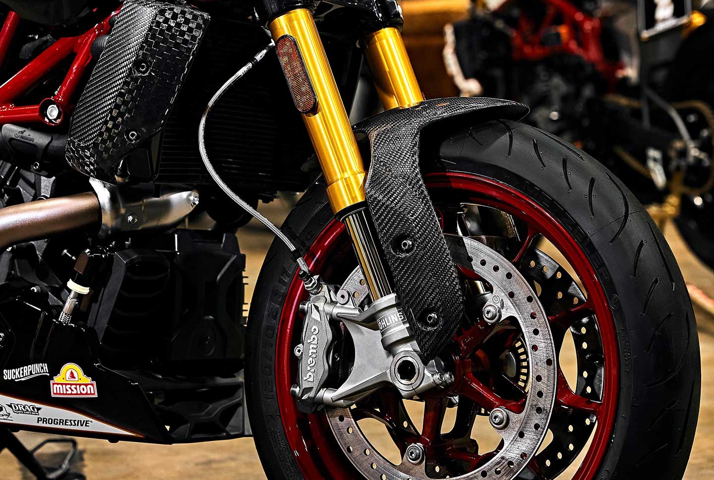 As on the FTR R Carbon trim, stopping power is provided by dual disc Brembo brakes up front. Carbon-fiber-y accents abound.