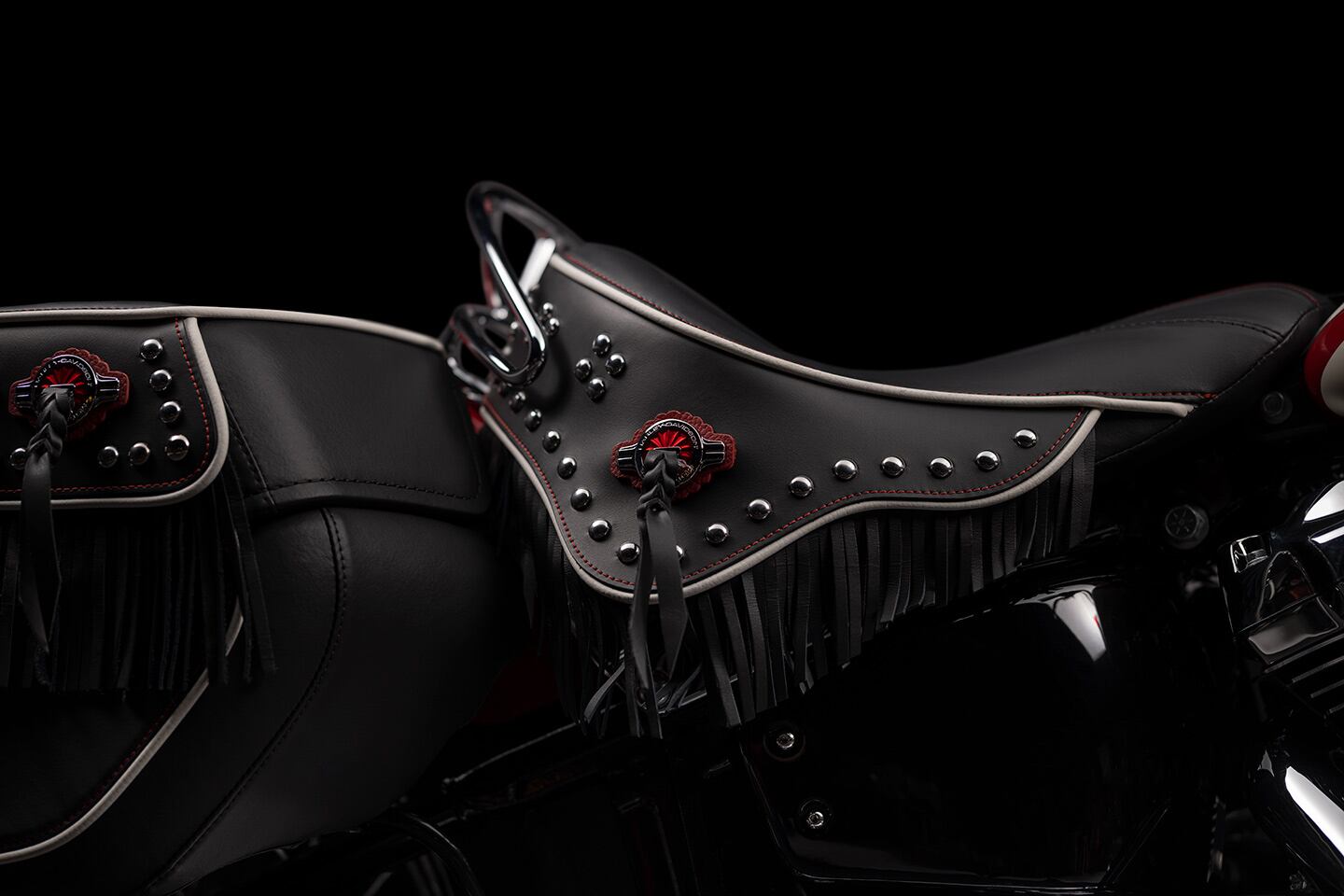 The Hydra-Glide's solo saddle is embellished with fringe, contrast stitching, piping, and 
